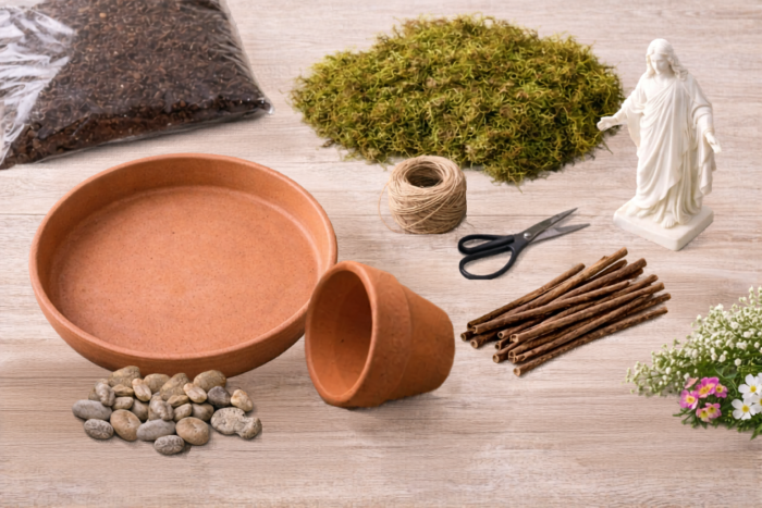 Supplies for making a resurrection garden including a terracotta saucer, moss, clay pot, pebbles, twigs, twine, flowers, and white Christus statue